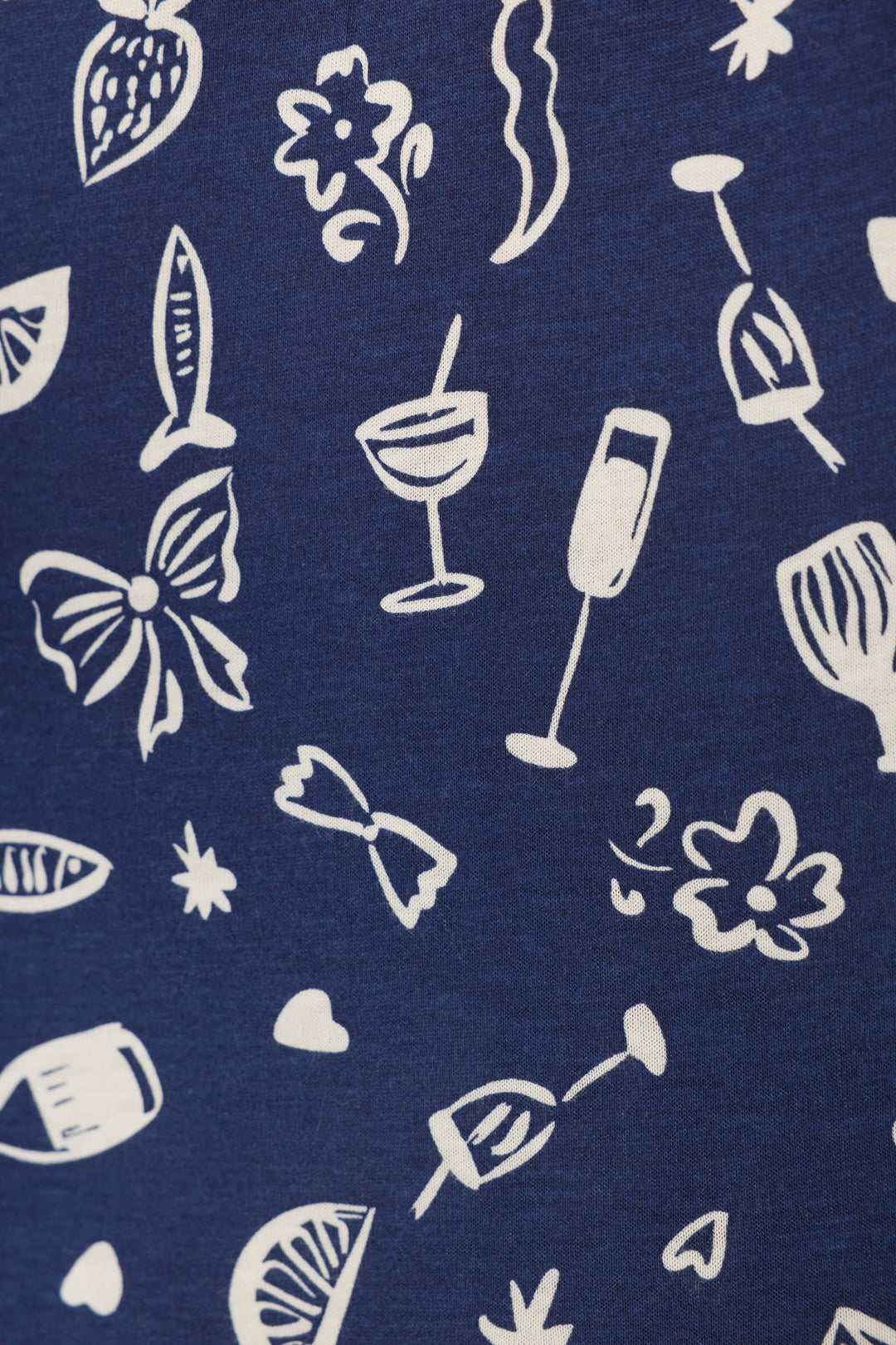 P.J. Salvage’s Playful Prints Al Fresco Bistro Sleep Shorts feature blue fabric with white cocktail, wine glass, citrus, and floral motifs—perfect for bringing the lively vibe of the Italian coast to your loungewear.