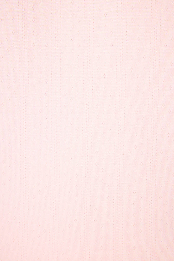 The Pointelle Essentials Ballet Pink Cardigan by P.J. Salvage features a light pink, textured surface with subtle vertical dotted lines and a faint diamond pattern, creating a consistent and elegant look throughout.