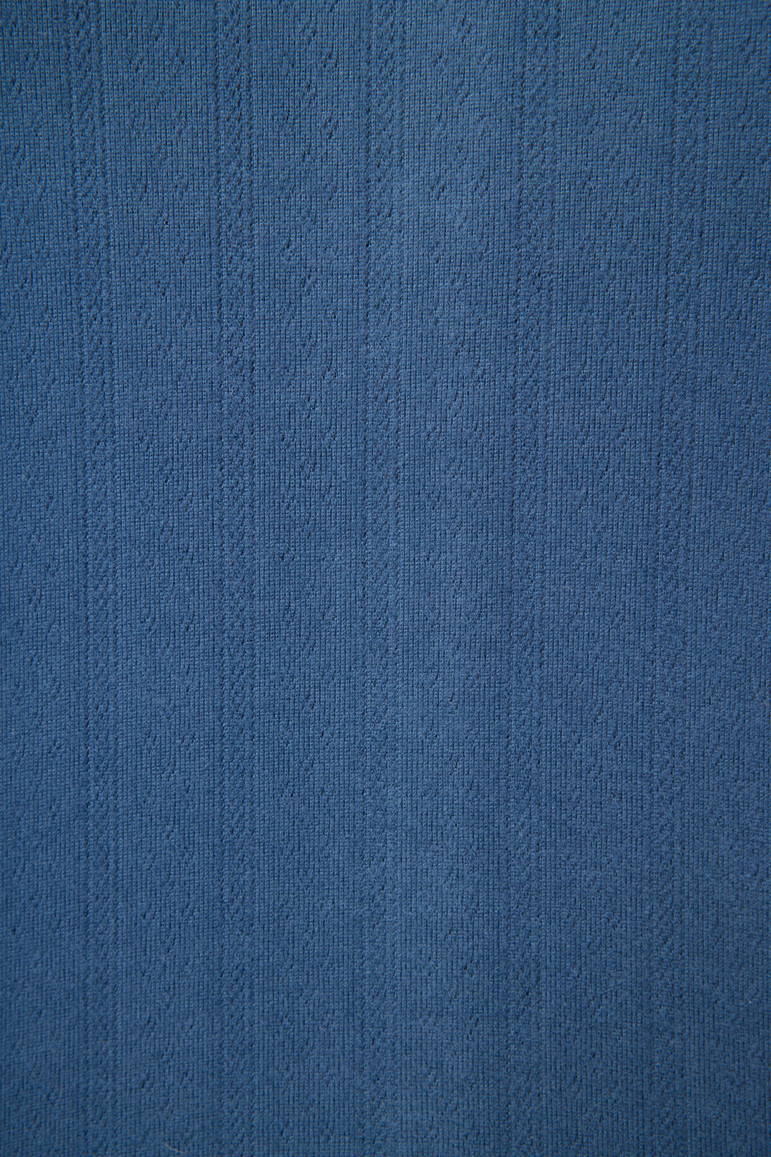Close-up of the P.J. Salvage Pointelle Essentials Deep Sea Open Leg Pants, showing textured blue fabric with vertical lines and a subtle woven pointelle pattern—ideal for lounge wear with small raised designs throughout.