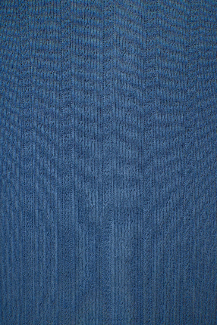 Close-up of the P.J. Salvage Pointelle Essentials Deep Sea Open Leg Pants, showing textured blue fabric with vertical lines and a subtle woven pointelle pattern—ideal for lounge wear with small raised designs throughout.