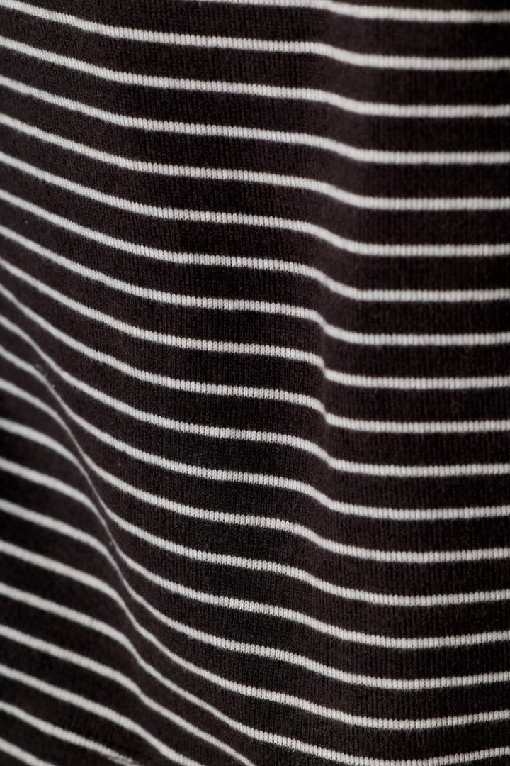 A close-up of a black knit fabric with thin, evenly spaced horizontal white stripes.