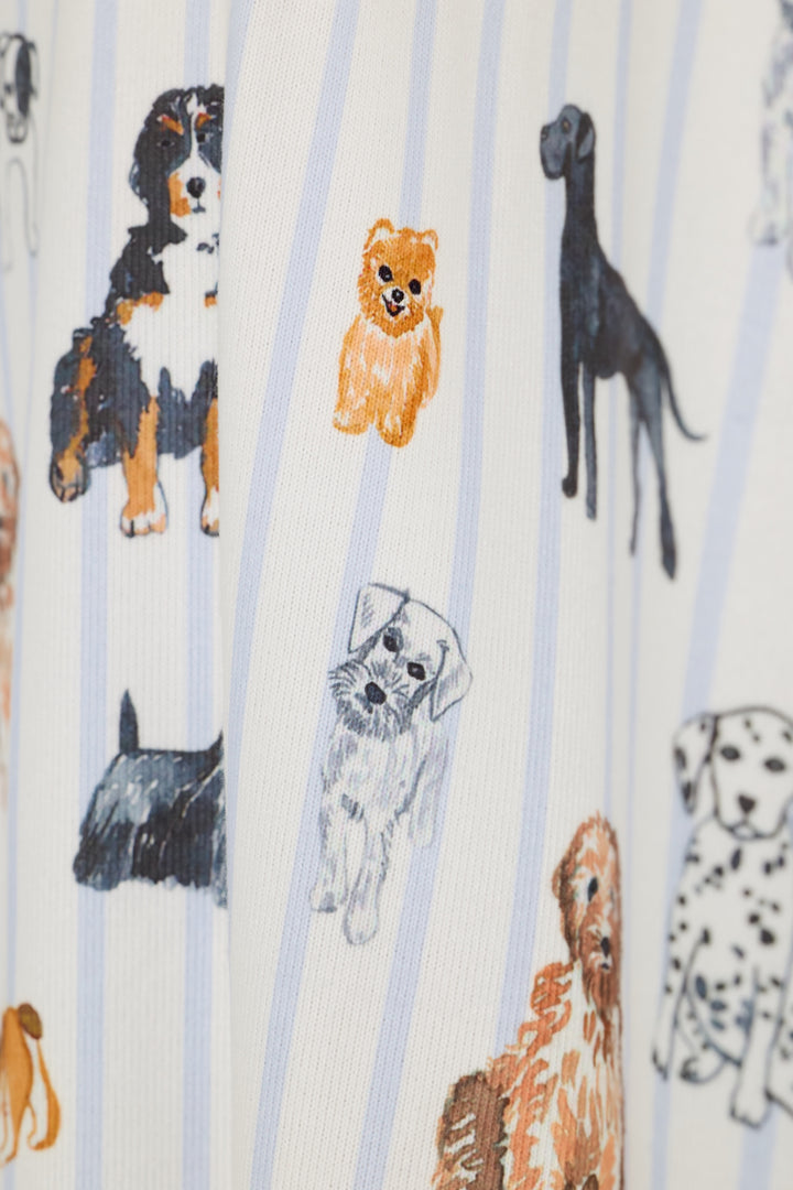 A close-up of a white fabric with light blue vertical stripes and an all-over print of various dog illustrations in black, brown, and white.