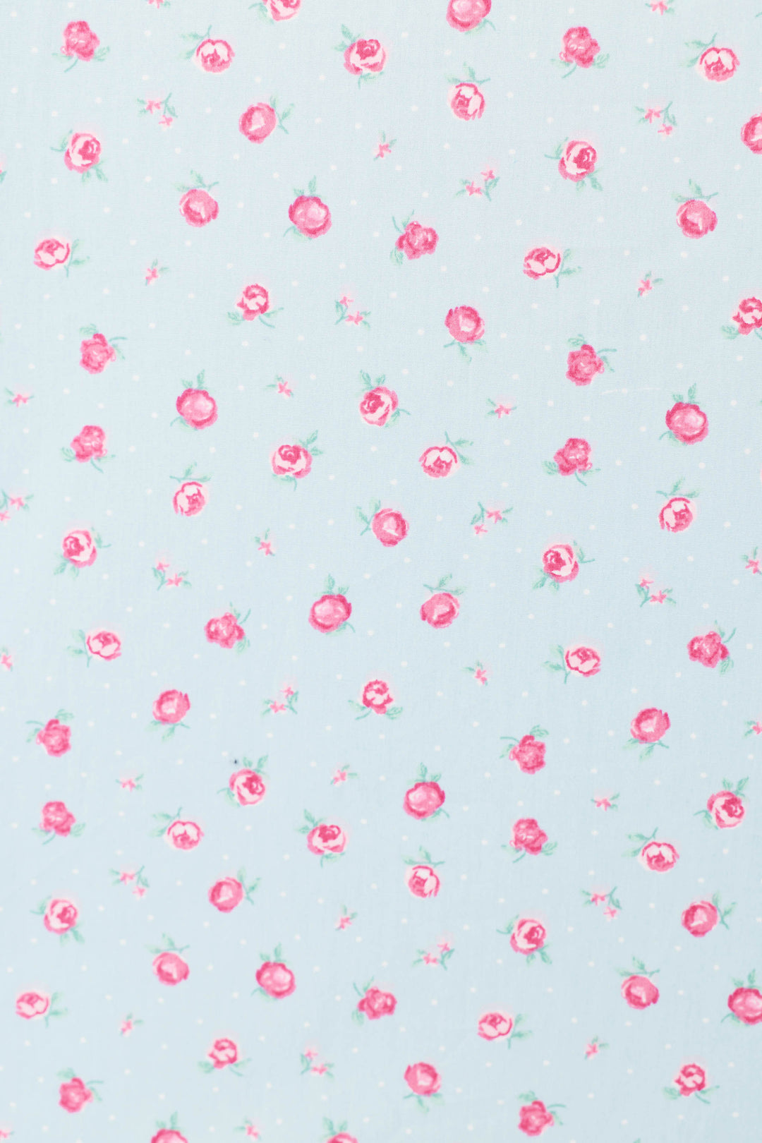 The Afterparty Poplin Rosy Nights Short PJ Set by P.J. Salvage features a light blue background with small pink roses, green leaves, and subtle white dots, printed evenly on soft cotton poplin—perfect for stylish comfort.