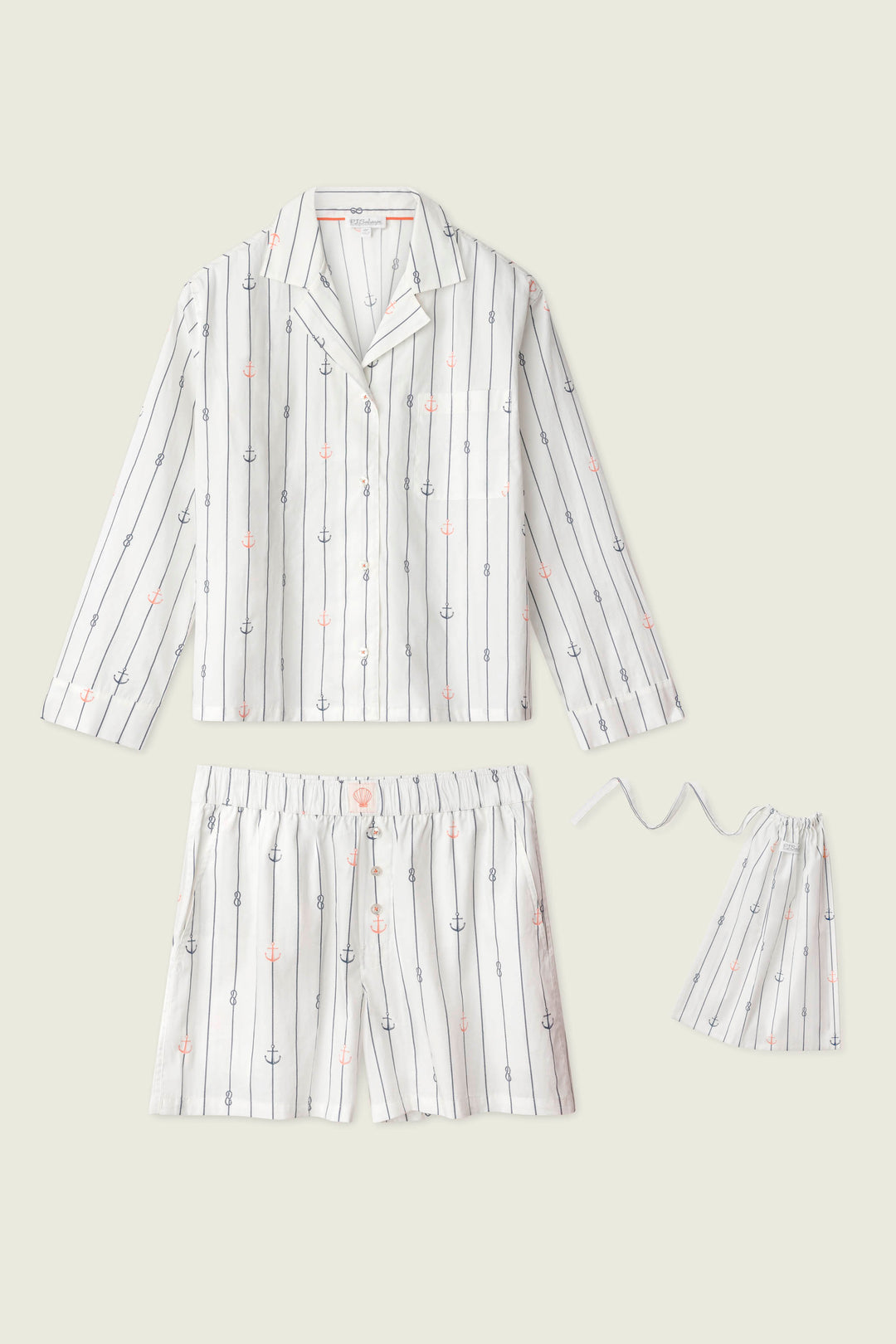 The Afterparty Poplin Anchors Away Short PJ Set by P.J. Salvage features cotton poplin pajamas with a long-sleeve button-up shirt, drawstring shorts, and a matching pouch in ivory with black stripes and pink/blue anchor patterns.