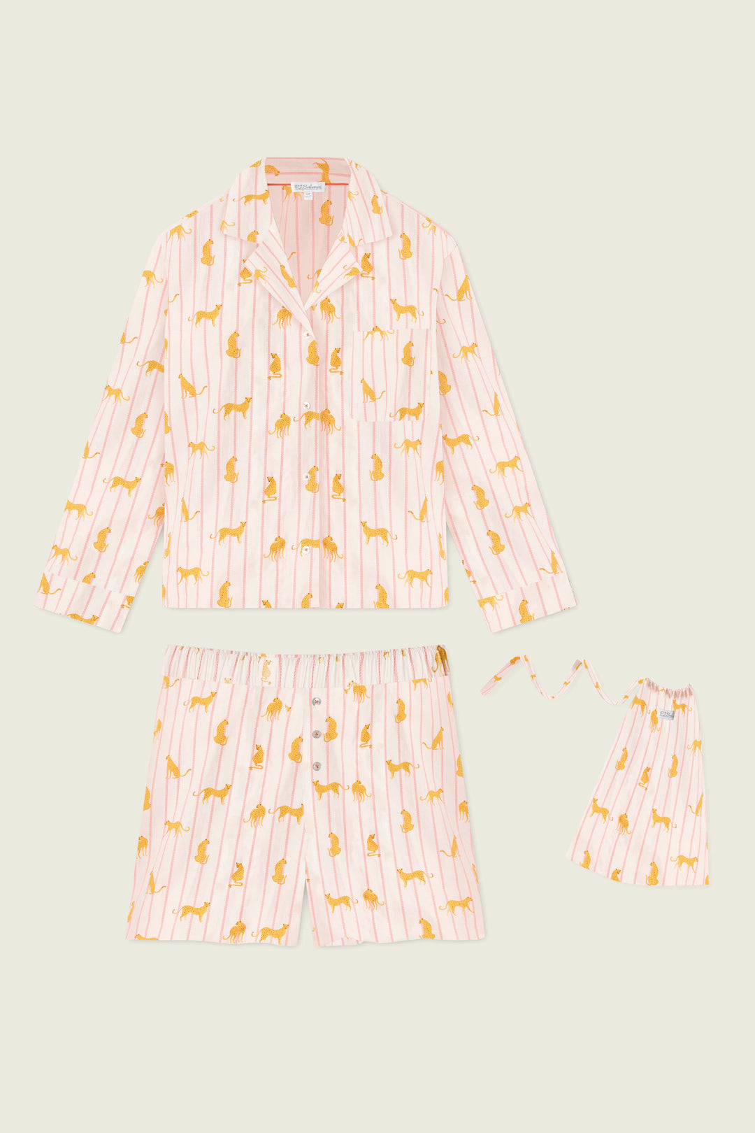 The Afterparty Poplin Cheetah Charm Short PJ Set by P.J. Salvage, featuring pink and white stripes, yellow cheetah print, a long-sleeve button-up shirt, drawstring shorts, and a matching pouch, is displayed on a light background.