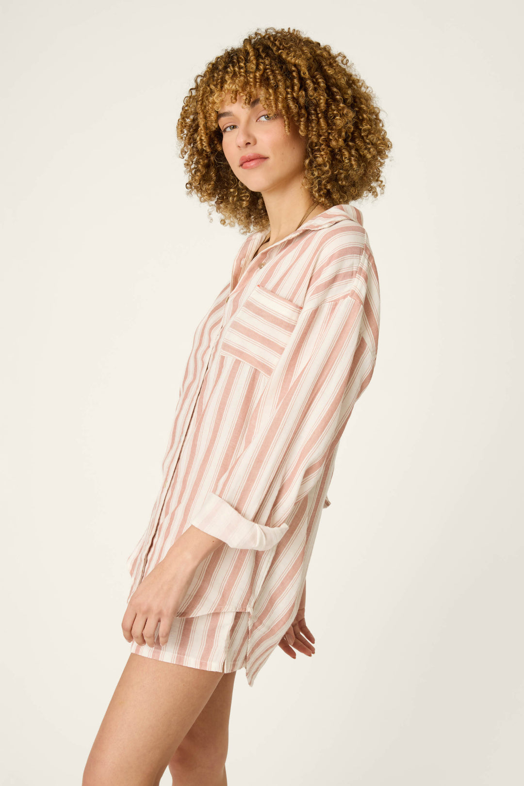 A soft pink and white striped fabric with a relaxed, oversized look, featuring horizontal stripes and lightweight texture.