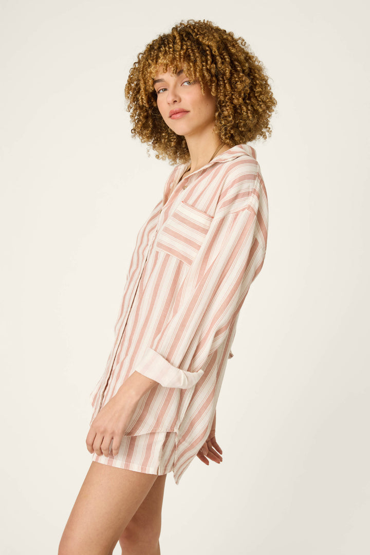A soft pink and white striped fabric with a relaxed, oversized look, featuring horizontal stripes and lightweight texture.