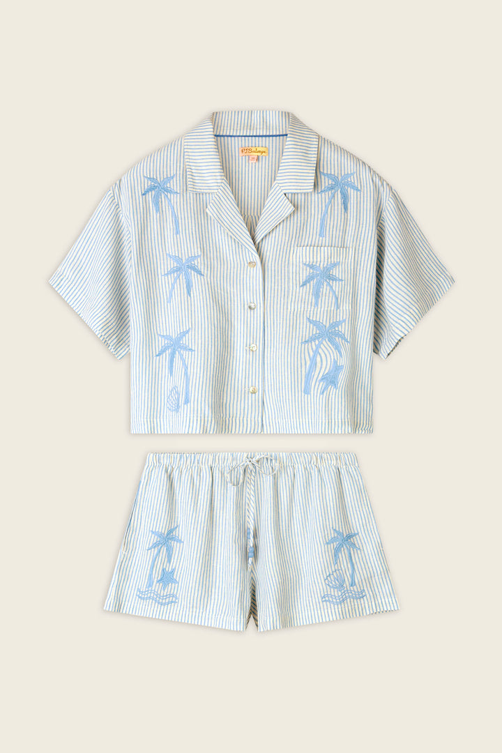 Thin blue and white stripes with blue palm tree lettering on a smooth fabric, shown flat against a neutral background.