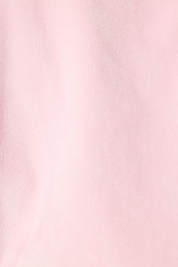 A close-up of the Luxe Plush Solid Pink Robe by P.J. Salvage showcases its soft, light pink fabric with a slightly fuzzy texture and subtle shading, reminiscent of plush fleece.