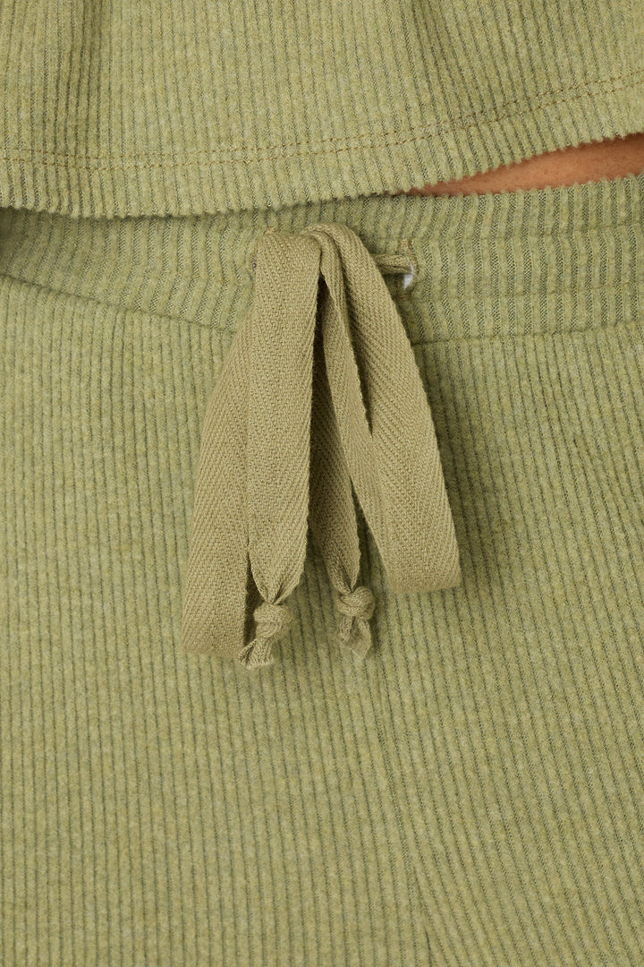 Close-up of P.J. Salvage Olive You Forever Lounge Pants in light olive green ribbed fabric, featuring a matching drawstring tied at the waist and detailed, visible texture.
