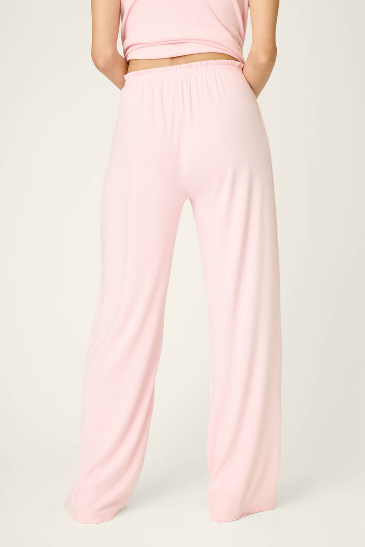 A person stands with their back to the camera against a plain light background, wearing P.J. Salvage Pointelle Essentials Ballet Pink Open Leg Pants and a matching sleeveless top.