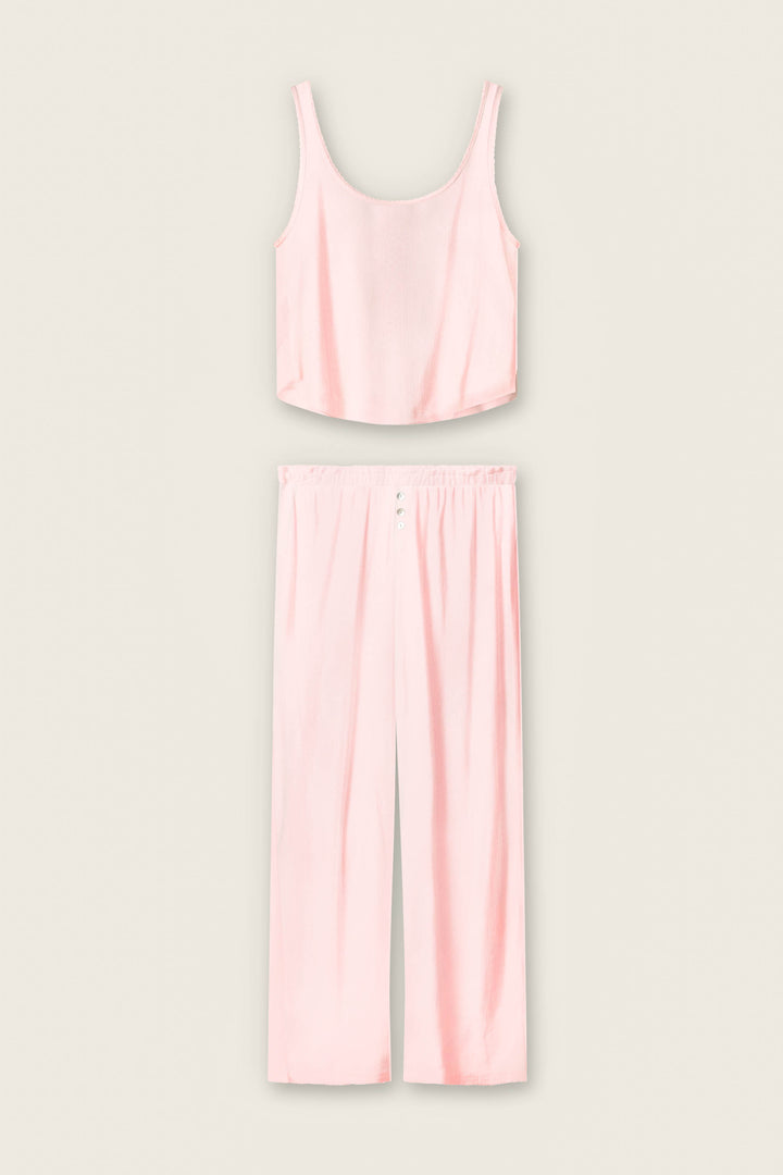 The P.J. Salvage Pointelle Essentials Ballet Pink PJ Set features a light pink satin two-piece with a sleeveless crop top and matching high-waisted, wide-leg pants with an elastic waistband, shown on a plain light background.