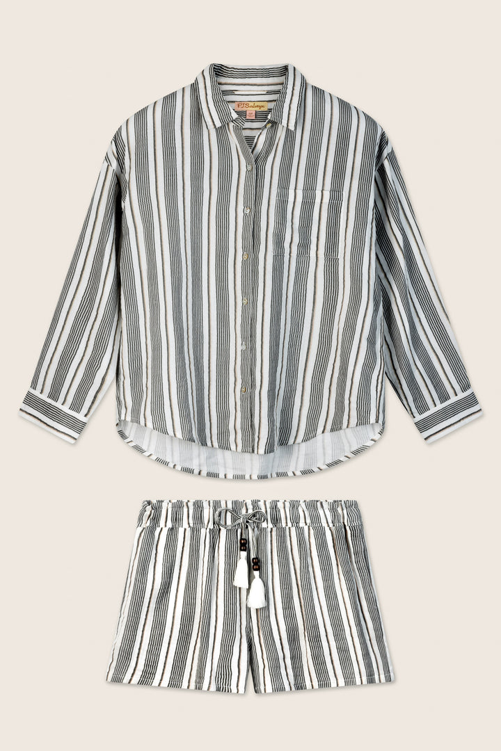 The P.J. Salvage Sea You in St. Tropez Shoreline Stripe Short Set features a relaxed button-front shirt and shorts in soft cotton double gauze with vertical black, white, and gray stripes, shown on a light beige background.
