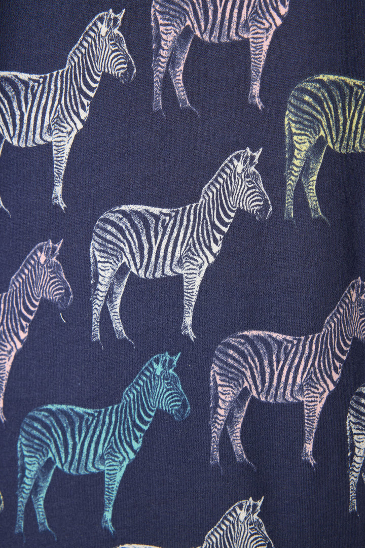 The Whimsy Technicolor Safari PJ Set by P.J. Salvage features a dark blue fabric patterned with multicolored zebras—white, yellow, blue, and pink—facing different directions for a playful look.