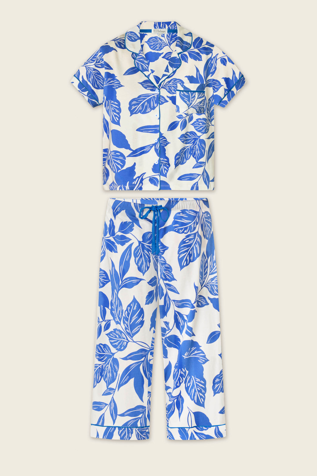 The Whimsy Sapphire Garden Cropped PJ Set by P.J. Salvage features a short-sleeve, button-up top and ankle-length, cuffed drawstring pants, both with a blue botanical leaf print on white.