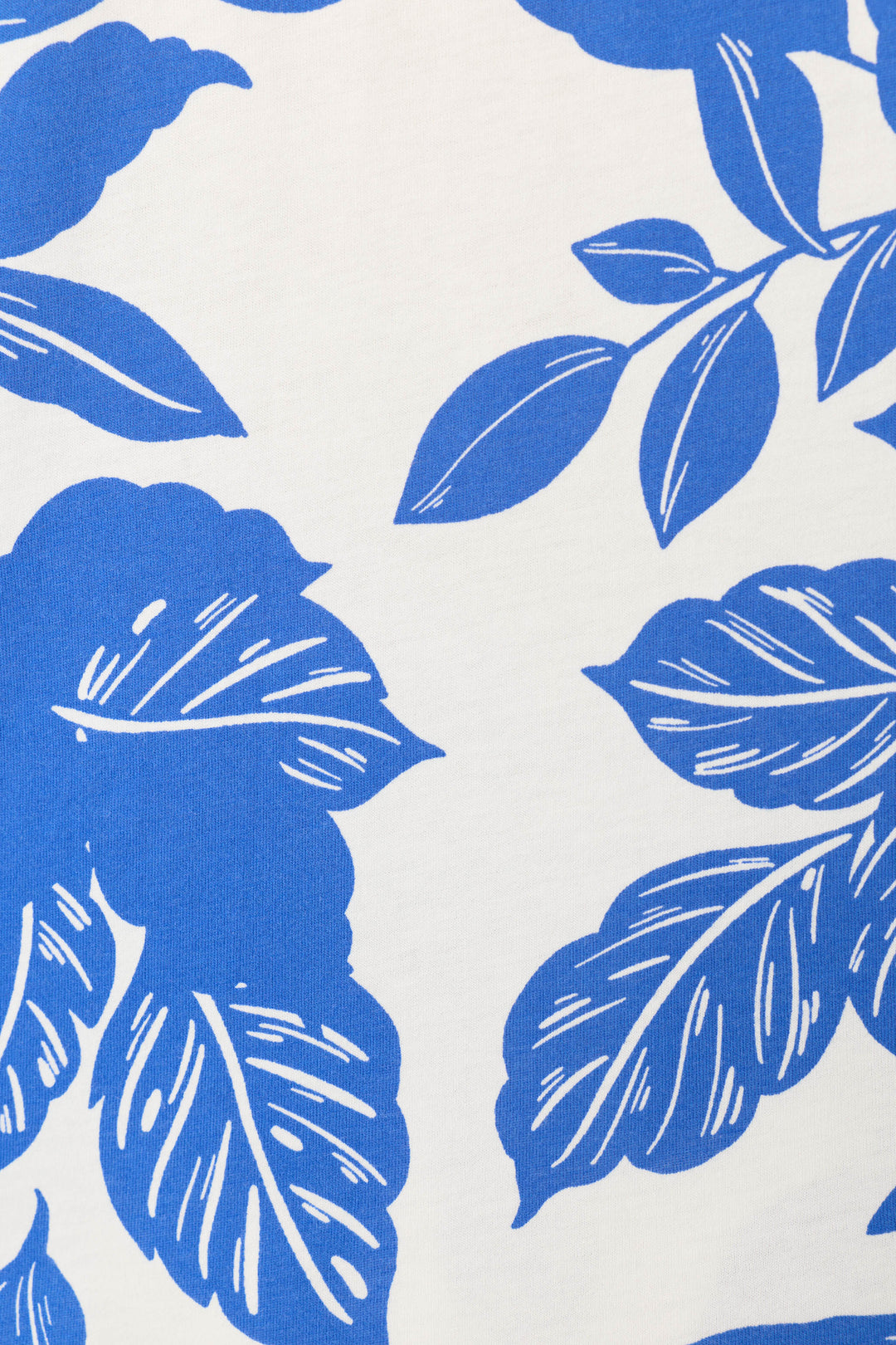 The Whimsy Sapphire Garden Cropped PJ Set by P.J. Salvage features a white background with blue, stylized leaves in varied sizes and directions, detailed with visible veins for a lively botanical look.