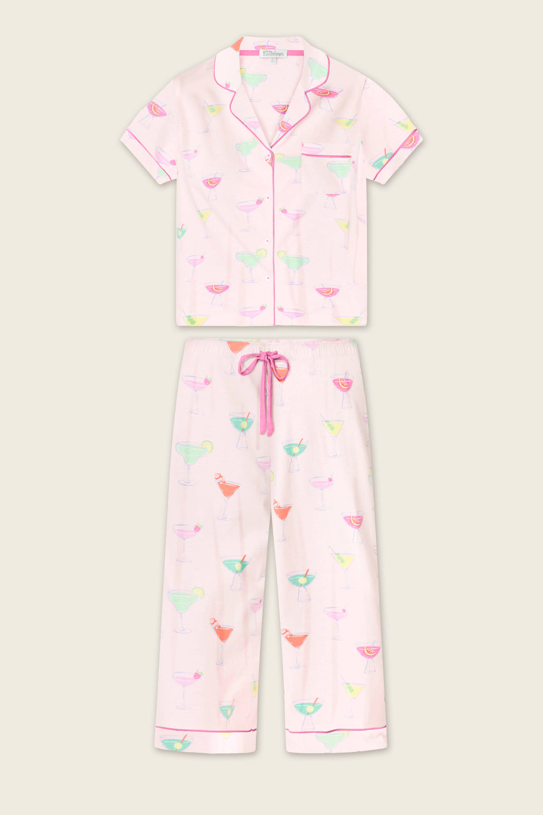 The Whimsy Sip Happens Cropped PJ Set by P.J. Salvage features a light pink short-sleeve button-up shirt and drawstring pants, both with colorful cocktail glass prints and pink piping.