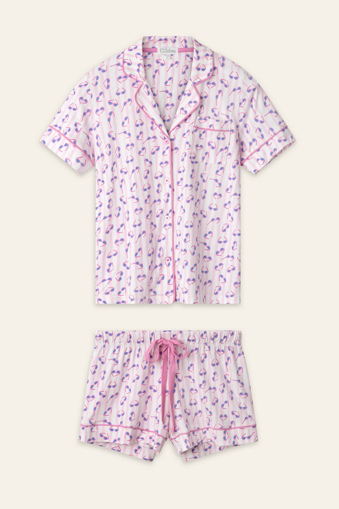 The Whimsy Retro Shades Short PJ Set by P.J. Salvage includes a short-sleeve button-up top and drawstring shorts with a pink and purple flamingo print on white, finished with pink trim.