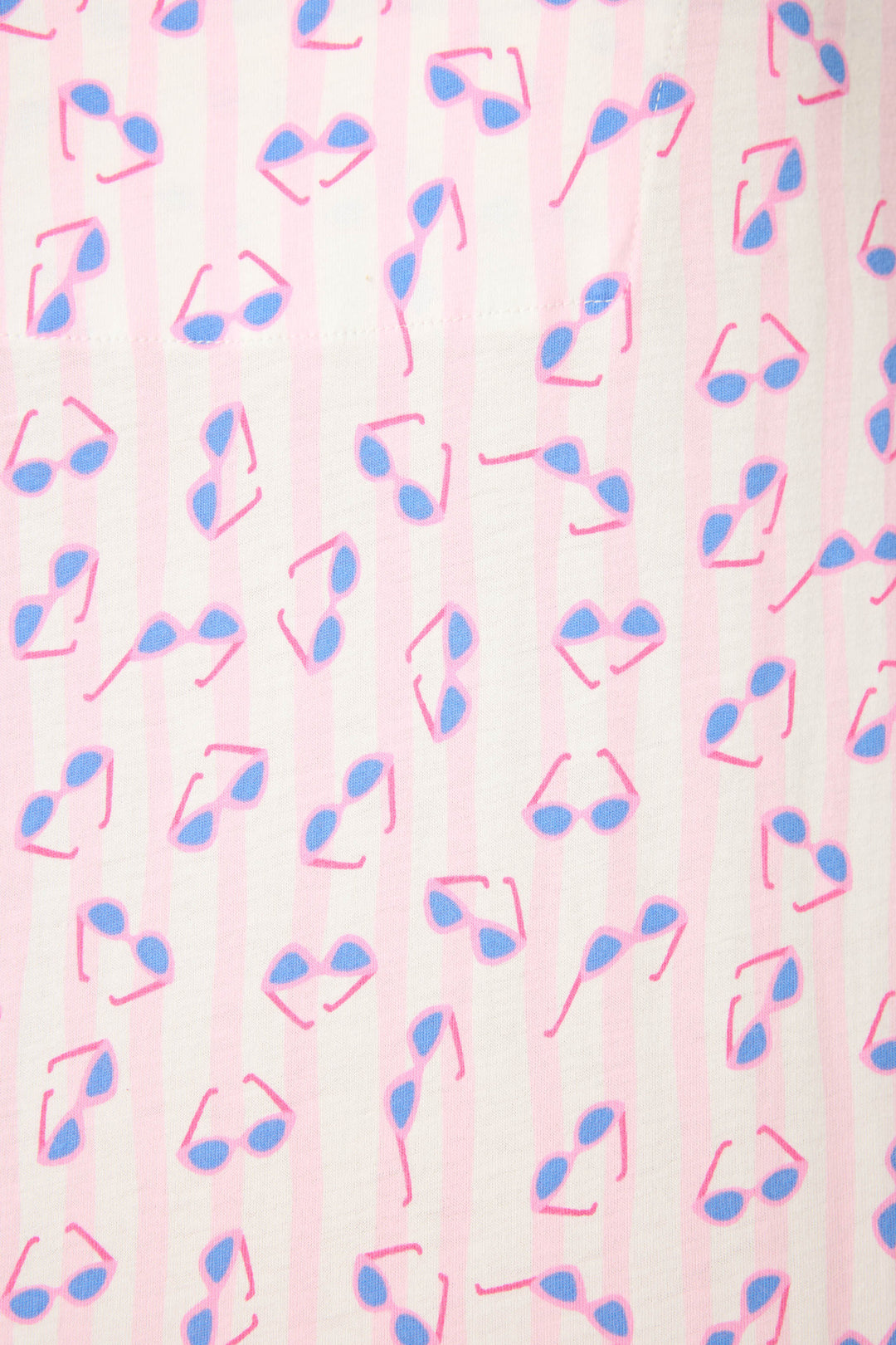 The Whimsy Retro Shades Short PJ Set by P.J. Salvage features an evenly spaced pattern of blue and pink sunglasses in various directions on a light pink and white striped background.