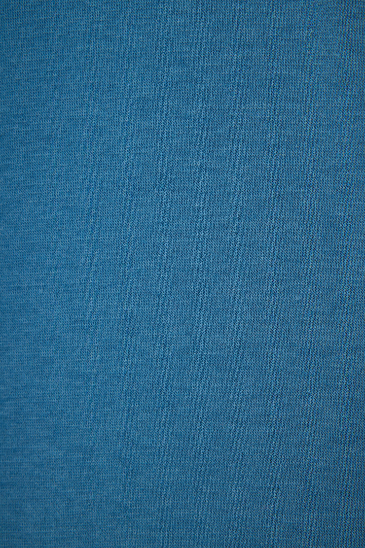 Close-up of the SHALOM CREW LONG SLEEVE YOU HAD ME AT SHALOM by P.J. Salvage, featuring smooth blue fabric with a fine, even knit texture that is uniform and free of visible patterns or designs.