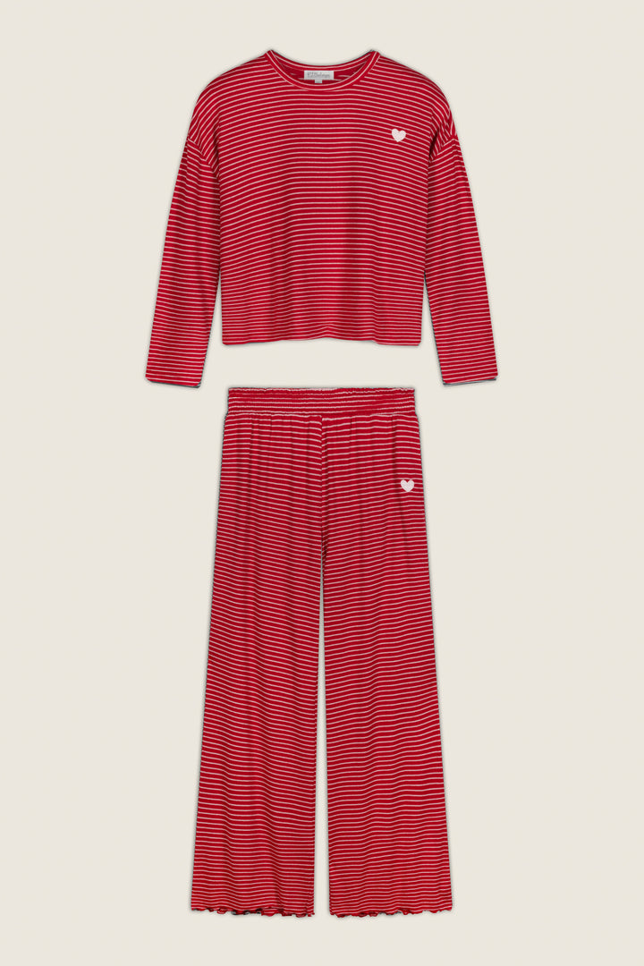 Icon Stripes Red Long Sleeve PJ Set featuring a red, long-sleeve top and wide-leg pants with thin white horizontal stripes, accented by a small white heart embroidered on the chest and hip.
