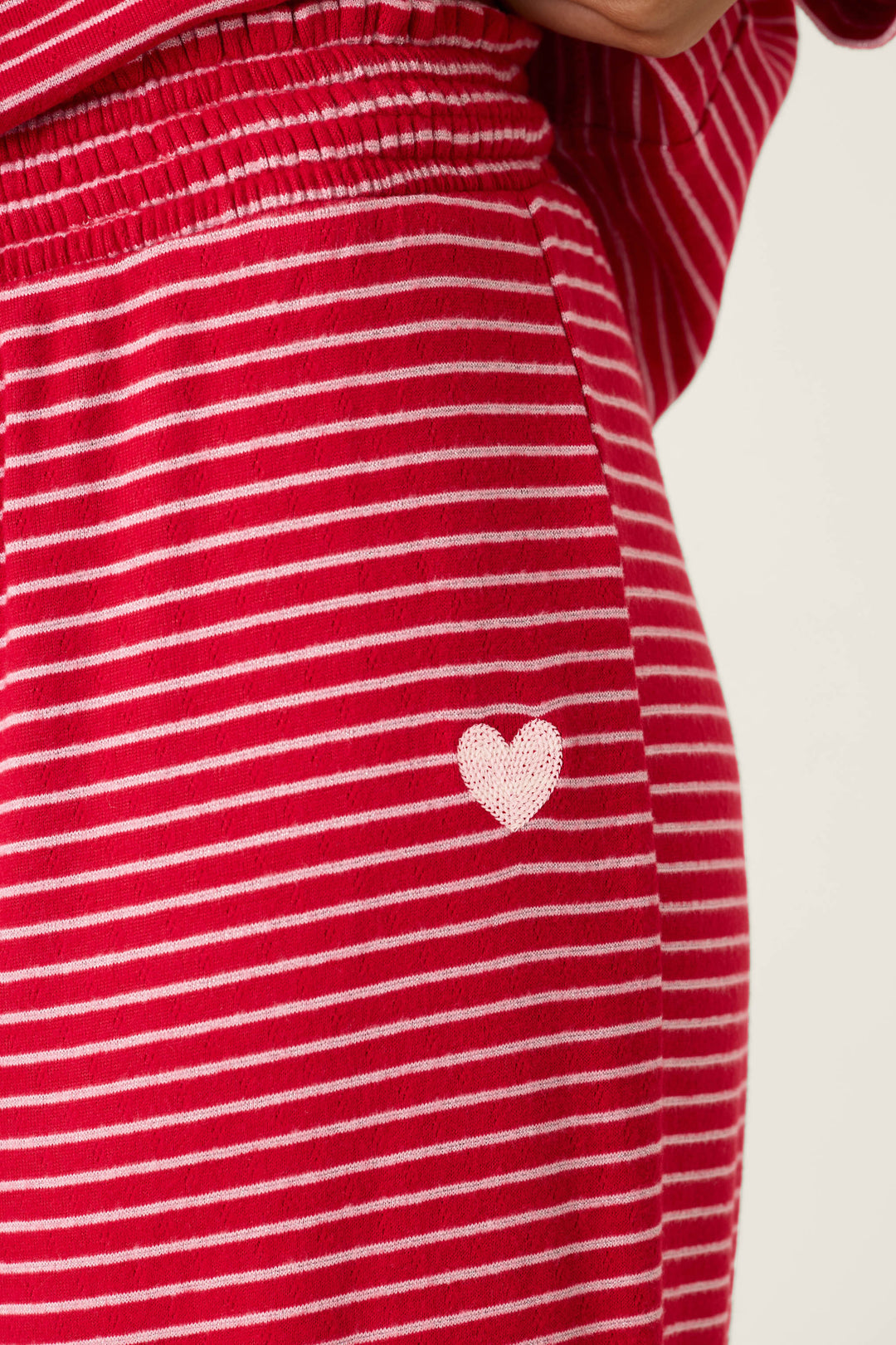 Icon Stripes Red Long Sleeve PJ Set in brushed pointelle featuring long sleeves, thin white horizontal stripes, and a small pink heart patch on the hip.