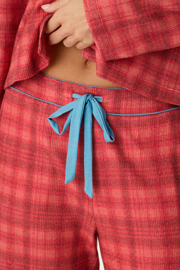 Mad for Plaid Pajama Pants in red plaid with a blue drawstring waist tie, worn with a matching top as cozy sleepwear.