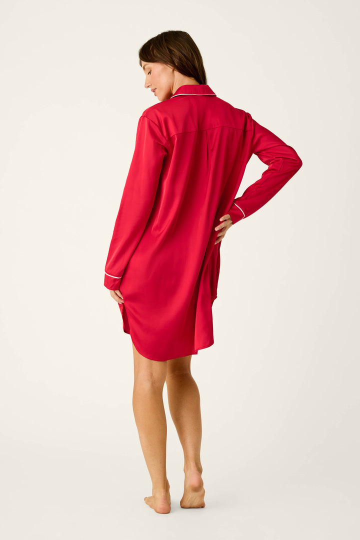 A woman seen from behind wearing a red P.J. Salvage Moonlight Muse Satin Nightshirt with white piping on the collar and cuffs.