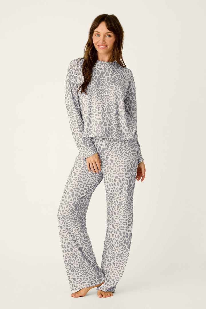 A woman wearing a cozy, grey and white leopard print Wild About You Leopard Print Long Sleeve PJ Set.