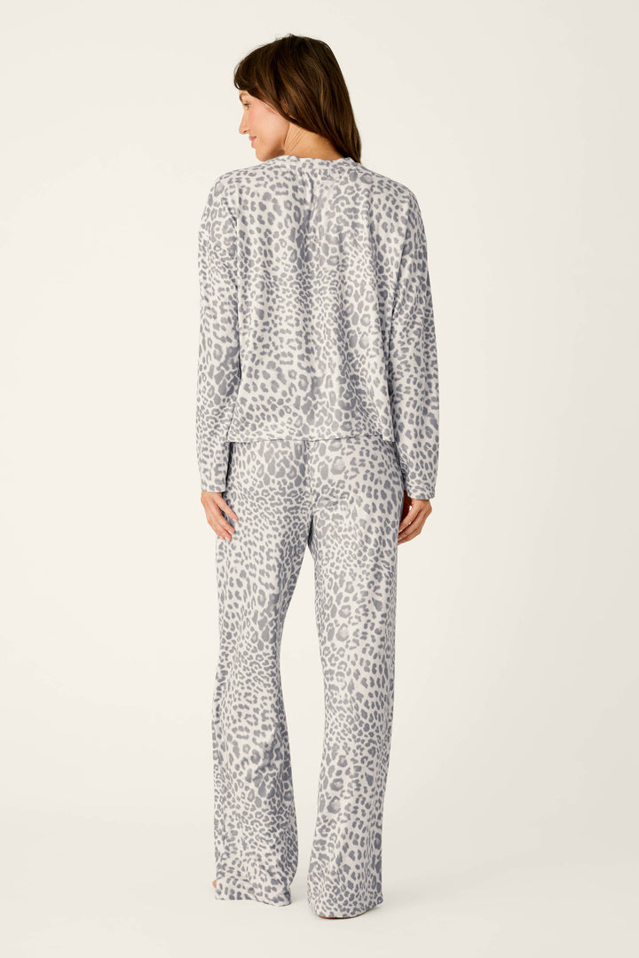 A woman viewed from behind wearing a P.J. Salvage Wild About You Leopard Print Long Sleeve PJ Set, featuring a cozy long-sleeve top and wide-leg pants.