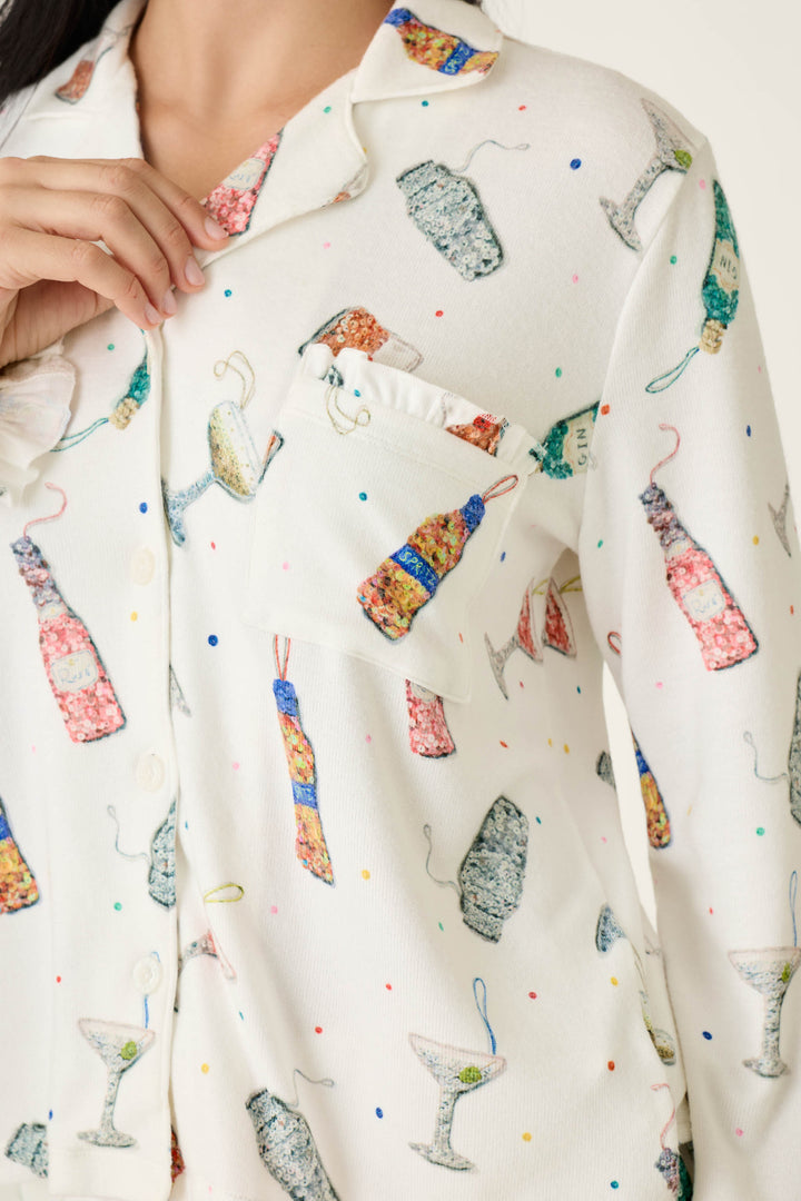 Off-white long-sleeved Sip Sip Sparkle Cocktail Charms Print 3-Piece PJ Set featuring a button-down top patterned with colorful cocktail bottles, glasses, and confetti dots.