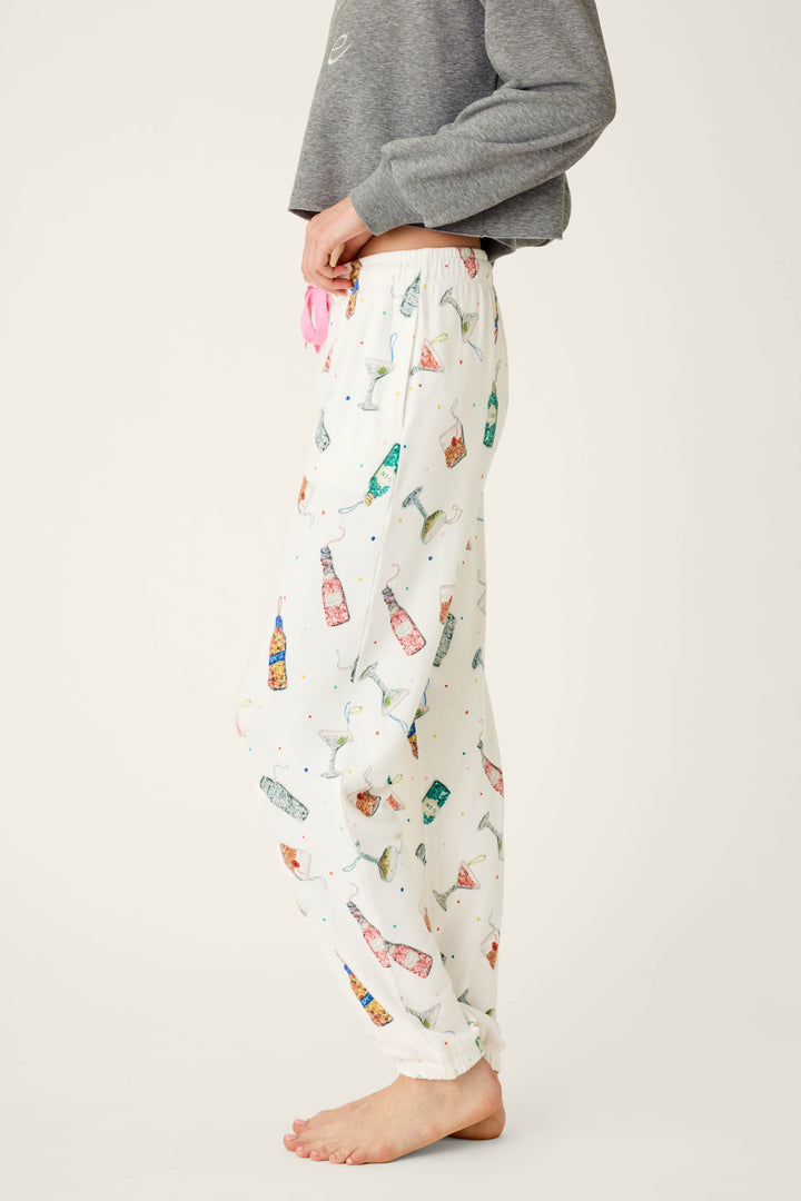 P.J. Salvage Sip Sip Sparkle Cocktail Charms Print Jogger Pant in peachy jersey with a colorful cocktail and confetti print and a pink drawstring waist.
