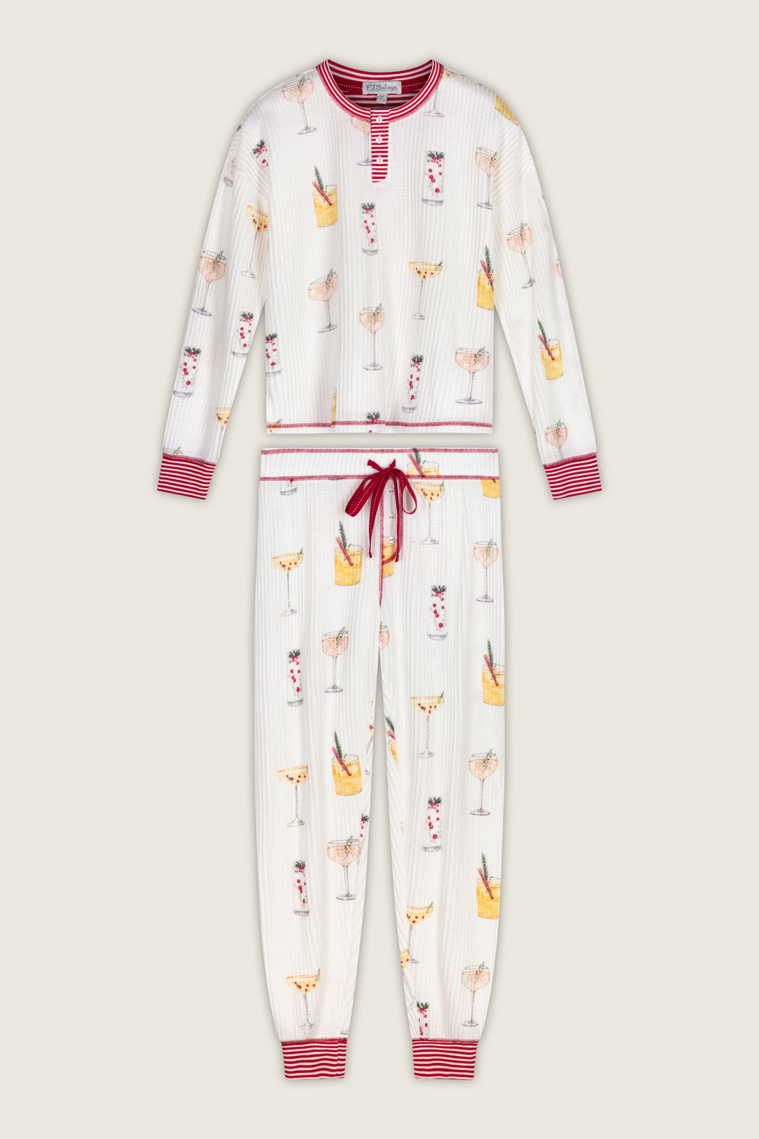 P.J. Salvage Ski Jammie Classics Cocktail Print Long Sleeve PJ Set featuring a long-sleeved henley top and matching jogger pants in an off-white waffle knit with a colorful cocktail print and red striped trim.