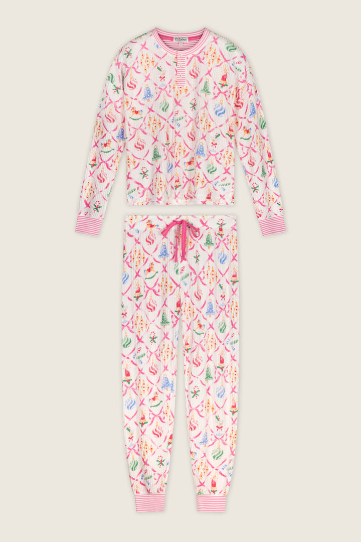 P.J. Salvage Ski Jammie Classics Ornament Print Long Sleeve PJ Set featuring a long-sleeve Henley top and matching joggers with a festive pink lattice pattern, colorful Christmas ornaments, and ribbons.