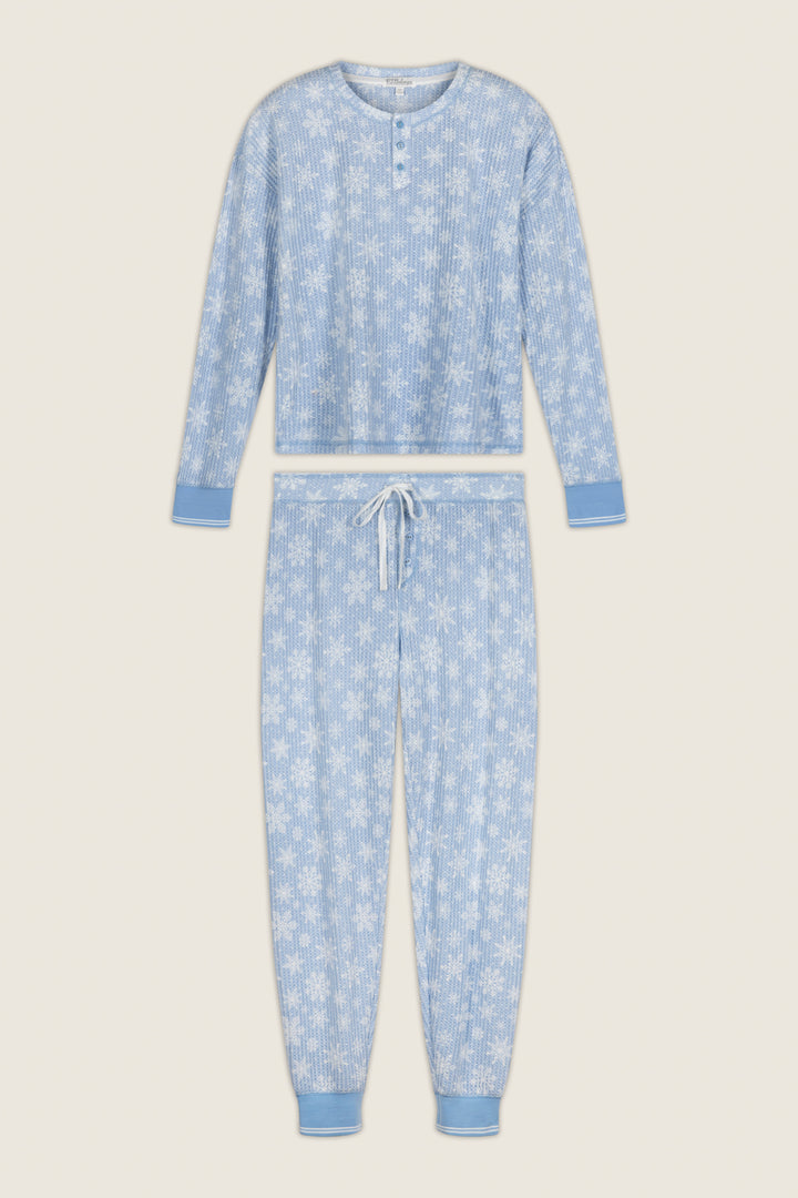 P.J. Salvage Ski Jammie Classics Snowflake Print Long Sleeve PJ Set featuring a light blue brushed thermal henley top and matching jogger-style pants with a white snowflake print.