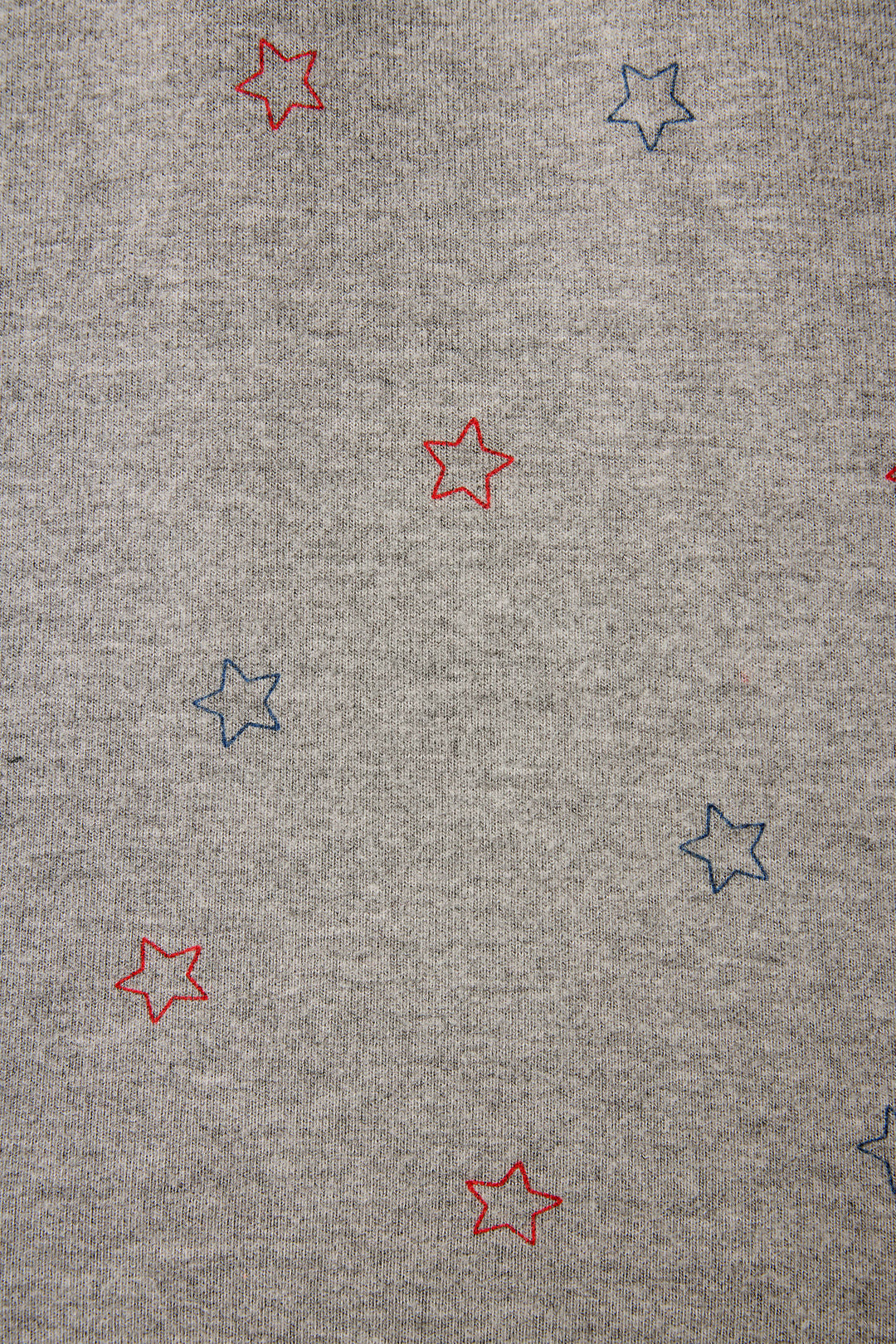 P.J. Salvage Red, White, & Woof Star Print fabric features a gray ground with small red and blue outlined stars evenly spaced all over.