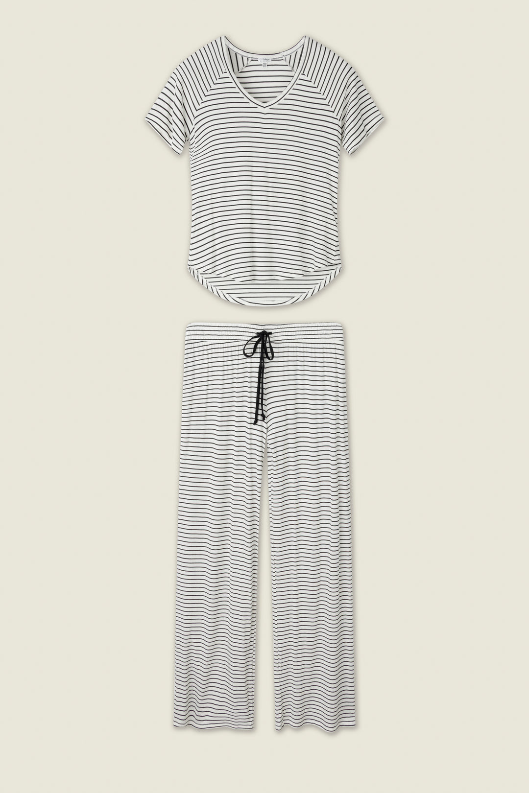 The P.J. Salvage Modal Basics Striped PJ Set features a soft modal jersey V-neck tee and wide-leg tie-waist pants in black and white stripes, both shown flat on a light background.