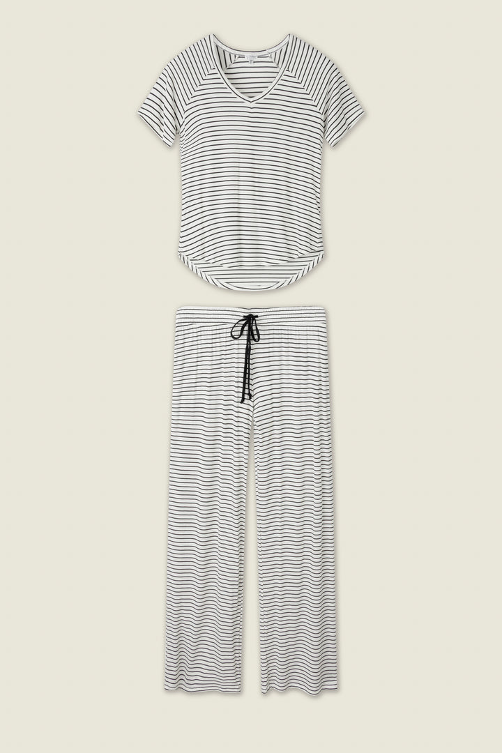 The P.J. Salvage Modal Basics Striped PJ Set features a soft modal jersey V-neck tee and wide-leg tie-waist pants in black and white stripes, both shown flat on a light background.