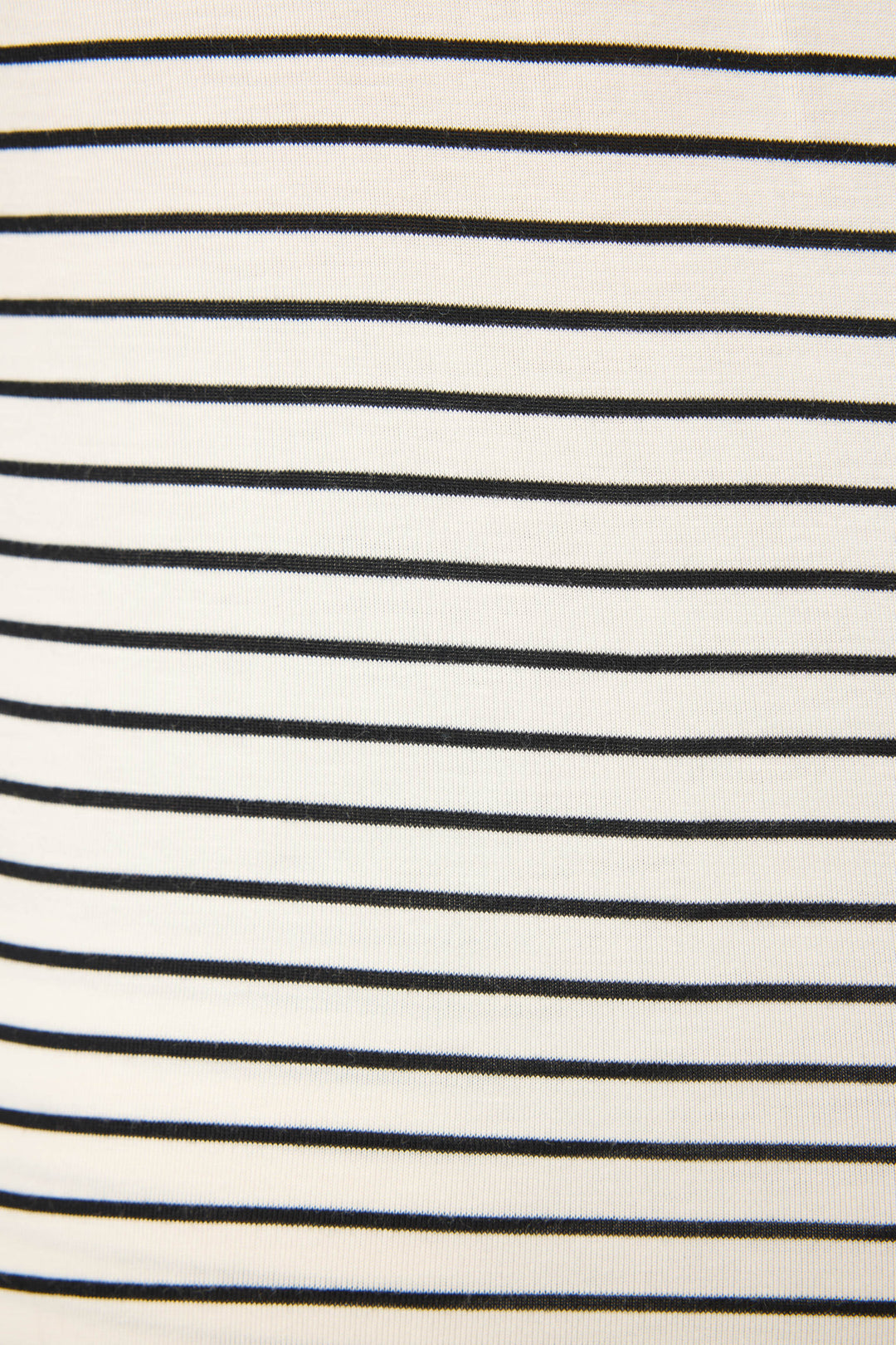 A close-up of the Modal Basics Striped PJ Set by P.J. Salvage highlights soft modal jersey fabric with evenly spaced black stripes on a white background, creating a timeless, classic striped look.