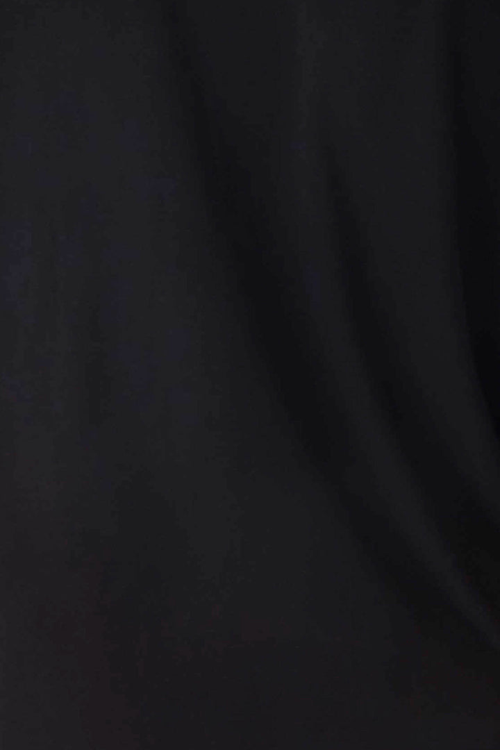 A close-up of the black fabric from the Jammie Essentials Short Black PJ Set by P.J. Salvage shows subtle folds and soft shadows, highlighting slight texture variations.