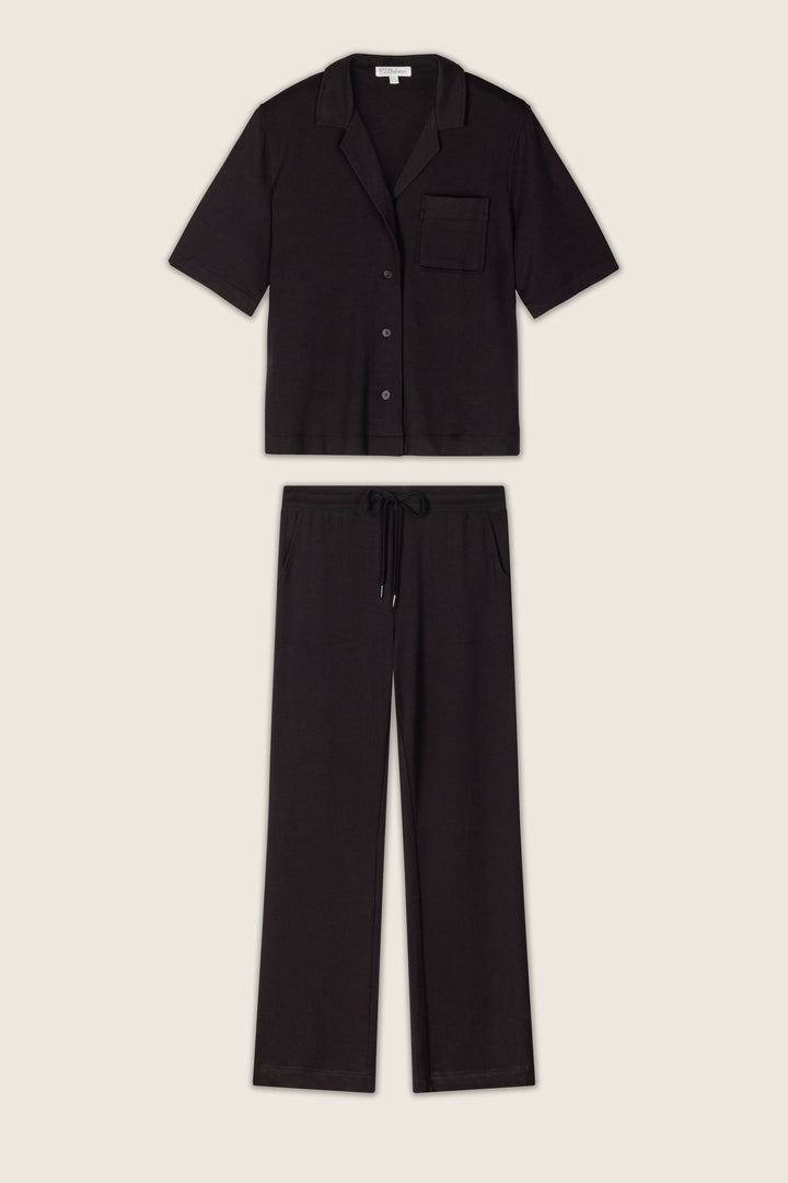 The black baby terry knit fabric has a soft, slightly textured appearance and is displayed on a neutral background.
