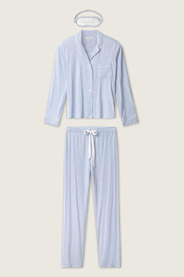 The P.J. Salvage Modal Basics Star Print 3-Piece PJ Set features a light blue, star-print long-sleeve button-up top, matching pants with a white drawstring, and a headband, all displayed flat on a beige background.