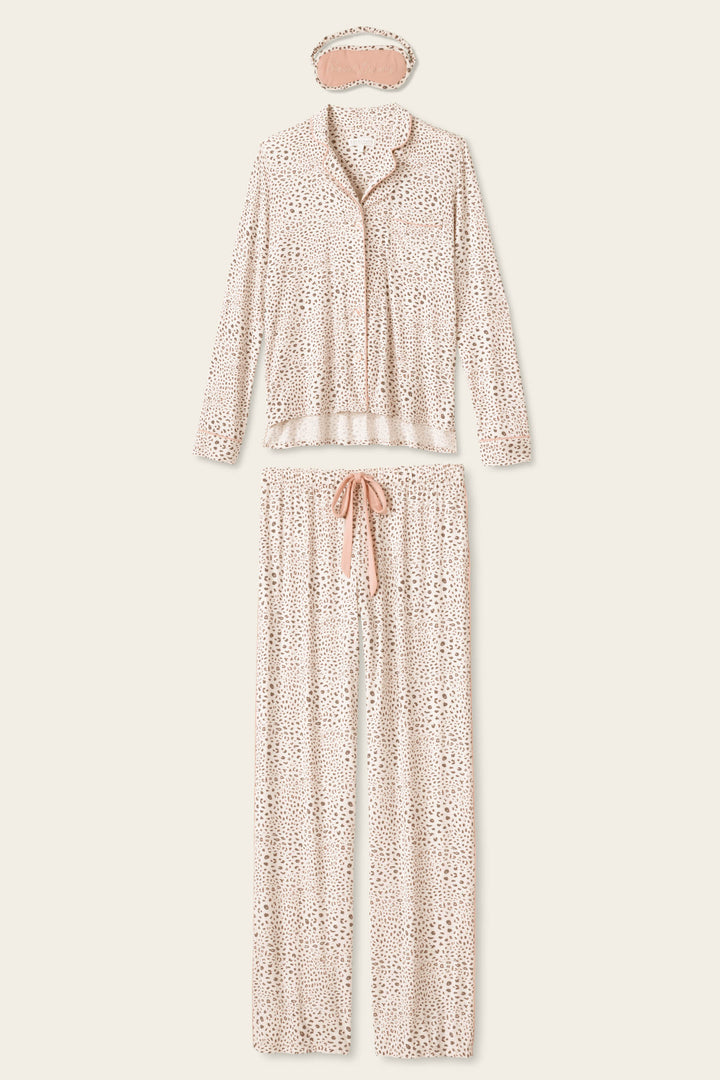 The Modal Dreams Leopard Print 3-Piece PJ Set by P.J. Salvage includes a soft modal jersey long-sleeve button-up top, drawstring pants, and a matching sleep mask in light beige with a small brown spotted pattern.