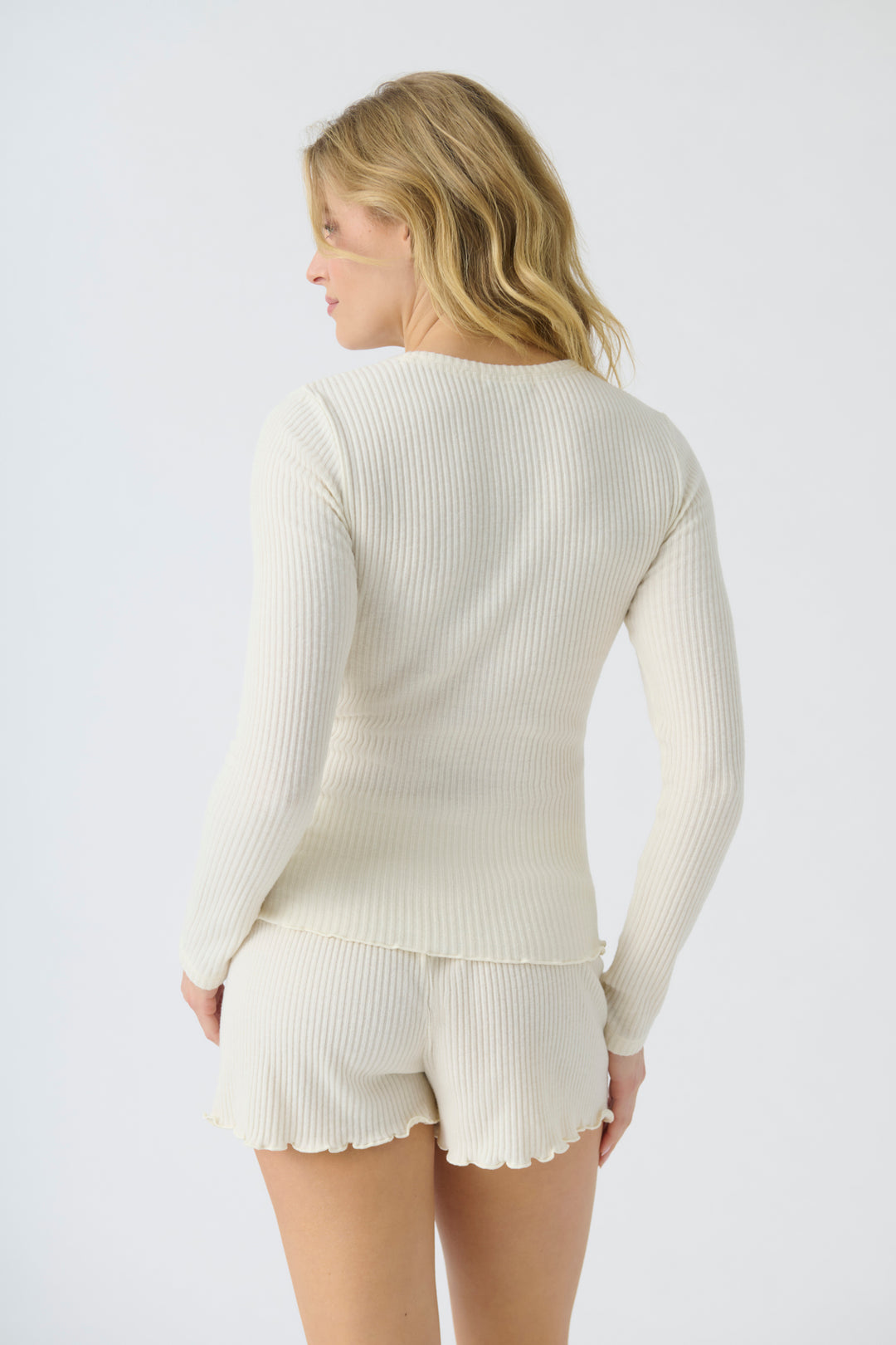 Women's ivory rib knit fitted long sleeve top & curly-edge hem