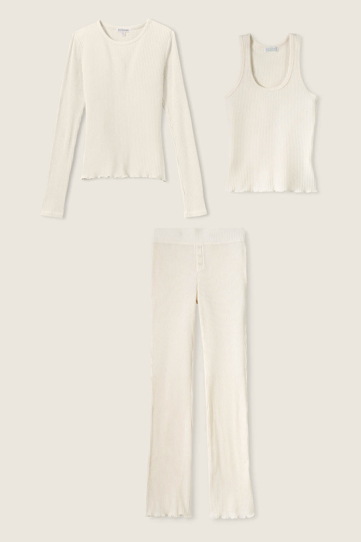 The P.J. Salvage Reloved Rib Natural 3-Piece Lounge Set features a cream ribbed long-sleeve top, sleeveless tank, and high-waisted pant with lettuce hems—crafted from sustainable REPREVE yarn.