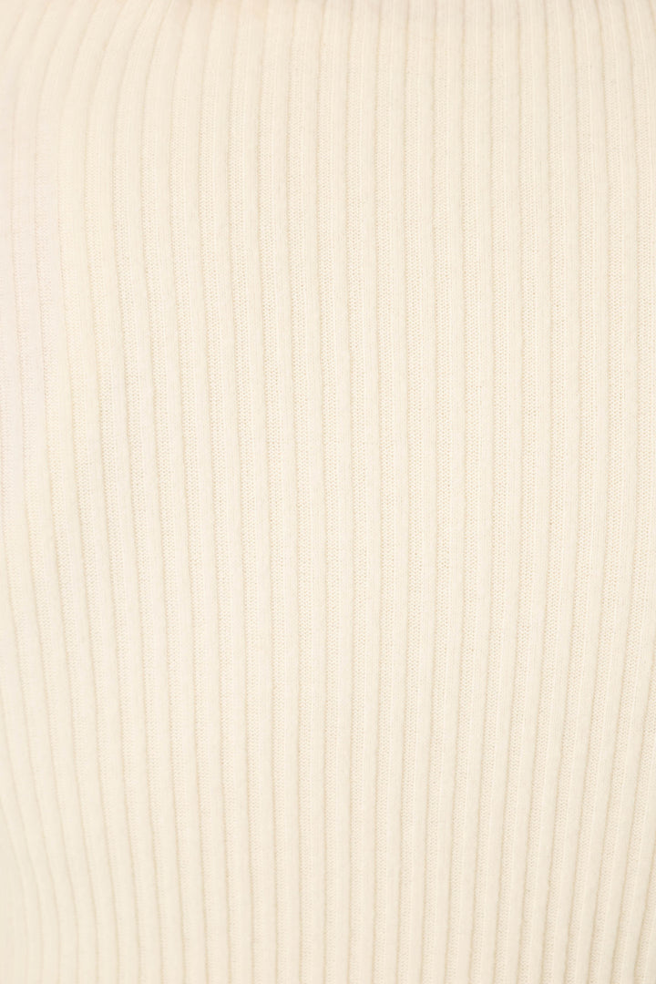 Close-up of the soft, light beige ribbed fabric featured in P.J. Salvage's Reloved Rib Natural 3-Piece Lounge Set, showcasing vertical textured lines and an evenly knit pattern ideal for comfy loungewear.