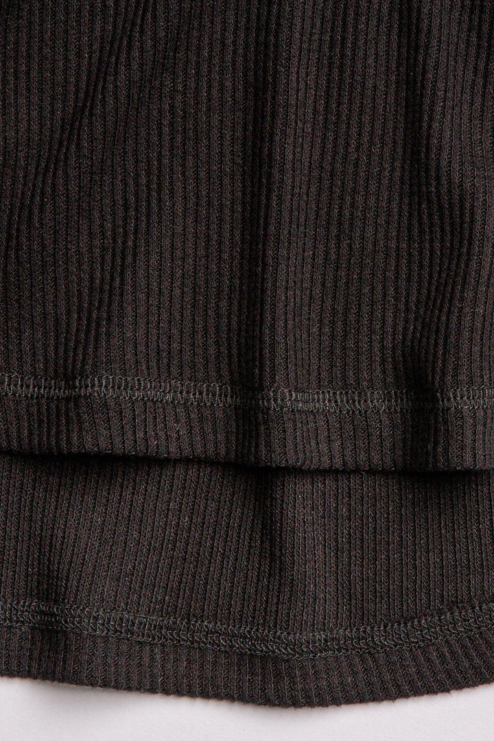 Black V-neck top with relaxed fit in 2x2 peachy rib. Banded sleeve cuff & neck rib. (7122611535972)