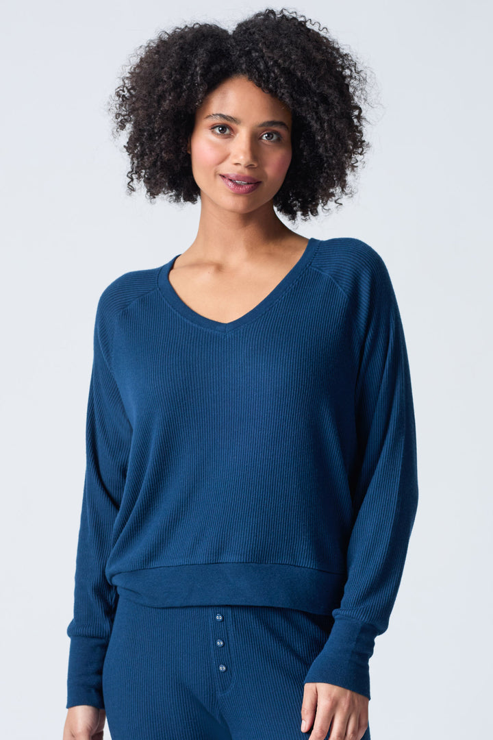 Navy V-neck top with relaxed fit in 2x2 peachy rib. Banded sleeve cuff & neck rib.