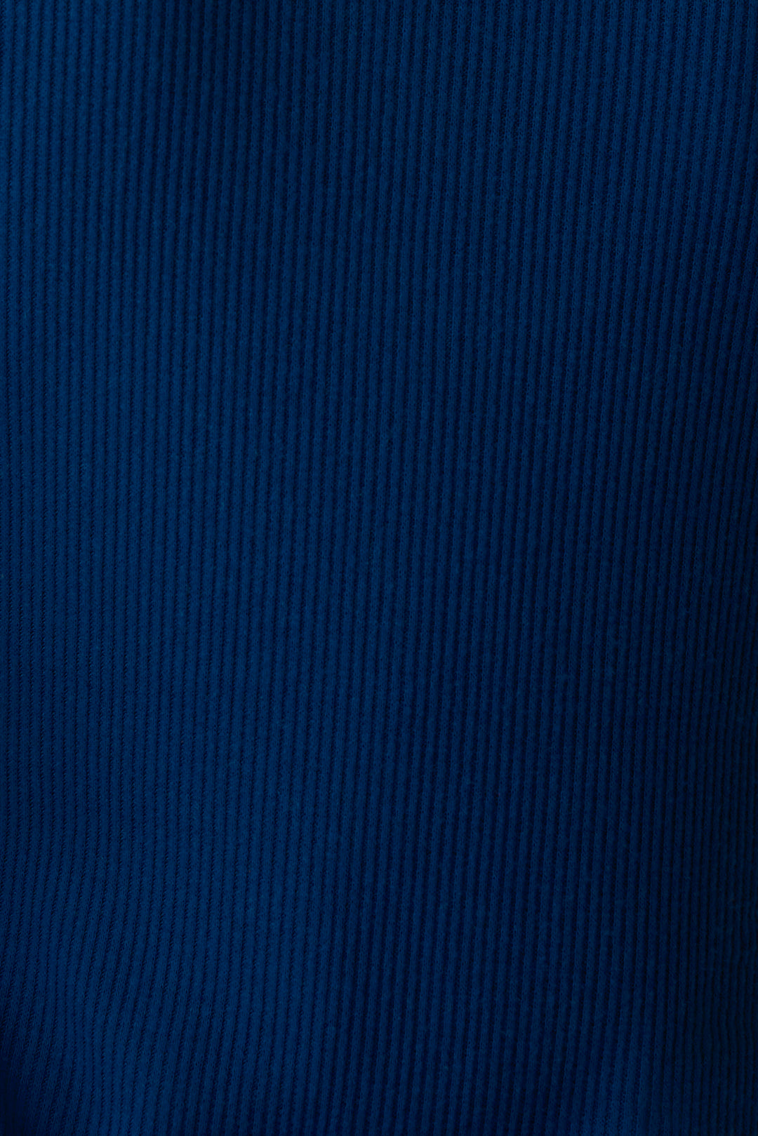 Navy V-neck top with relaxed fit in 2x2 peachy rib. Banded sleeve cuff & neck rib.