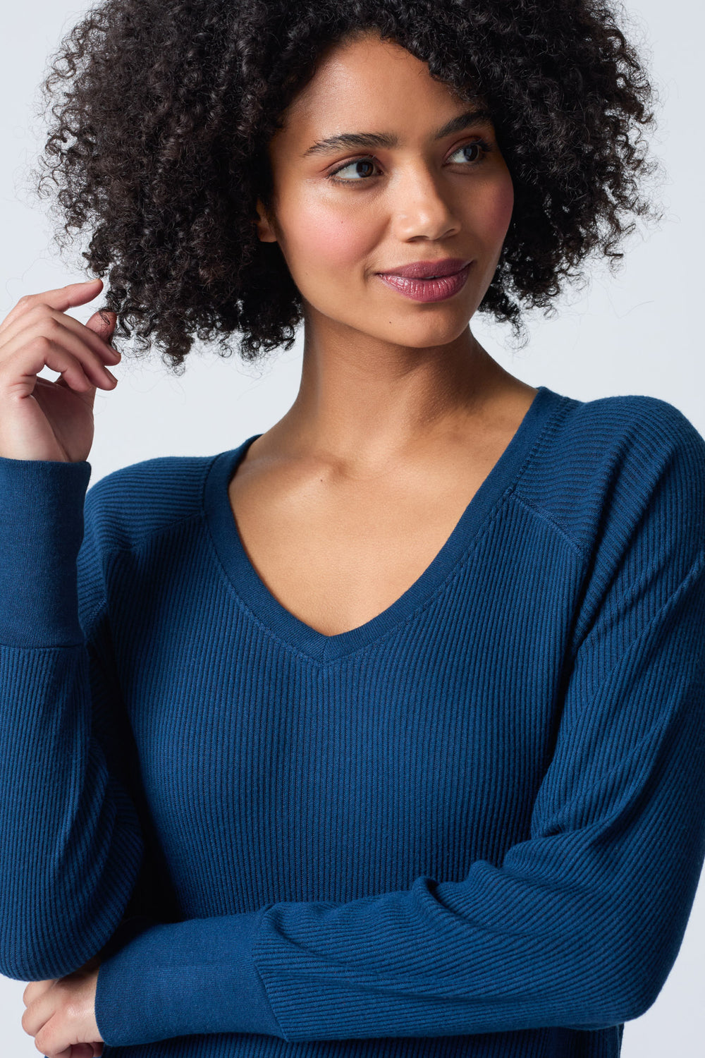 Navy V-neck top with relaxed fit in 2x2 peachy rib. Banded sleeve cuff & neck rib.